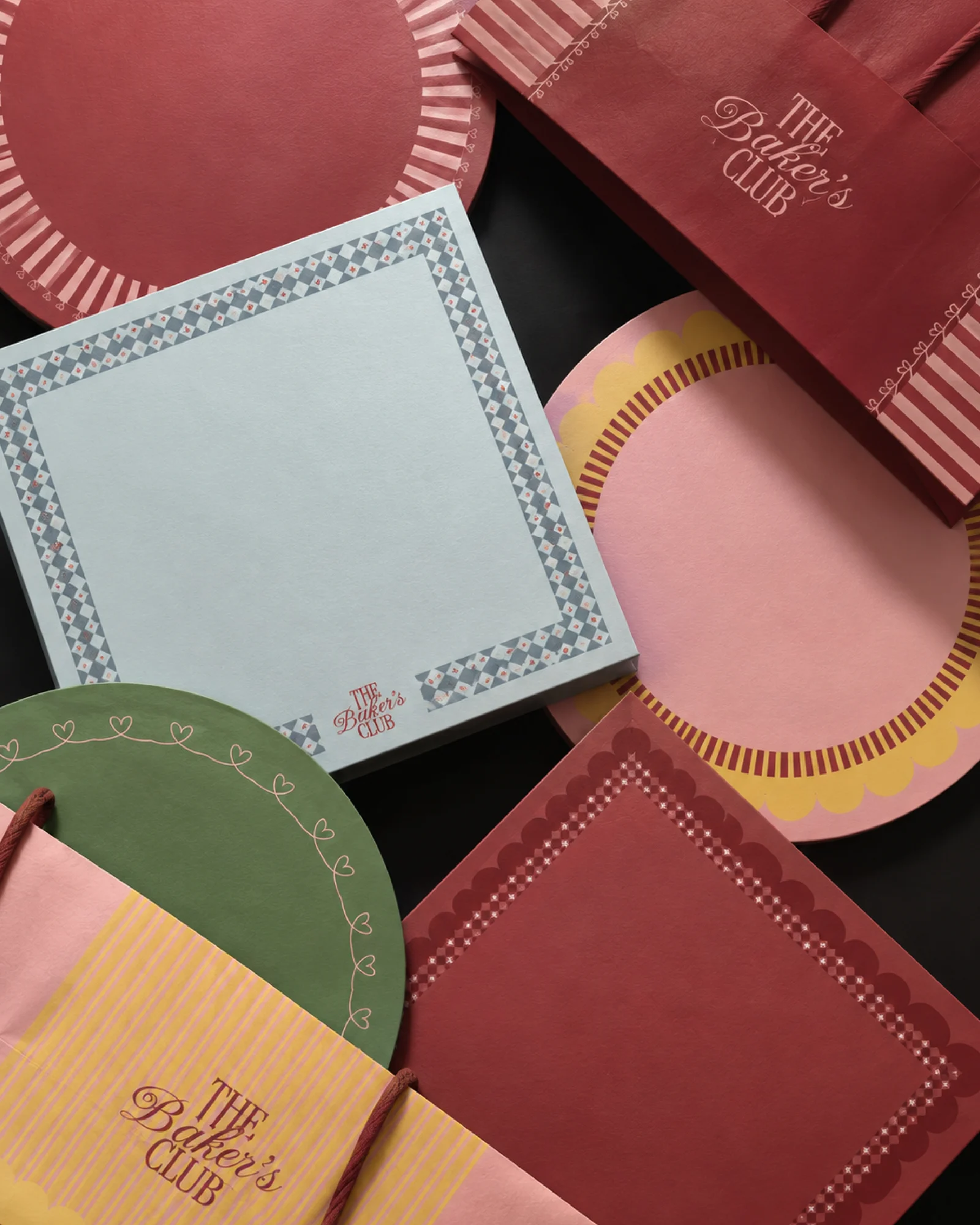 The Baker’s Club patterned bags, plates and paper in a colourful flat-lay