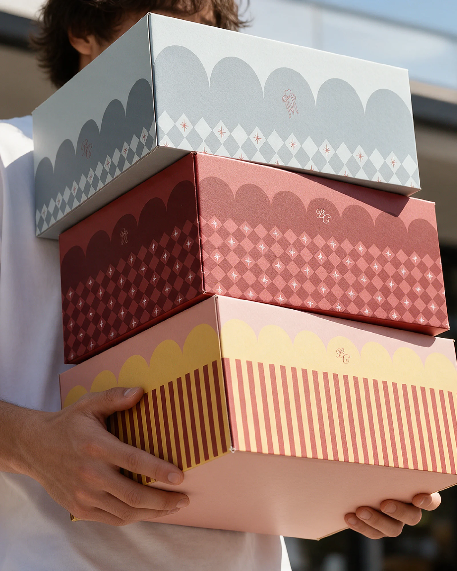 Stacked bakery boxes with scallops, diamonds and stripes in blue, red and yellow